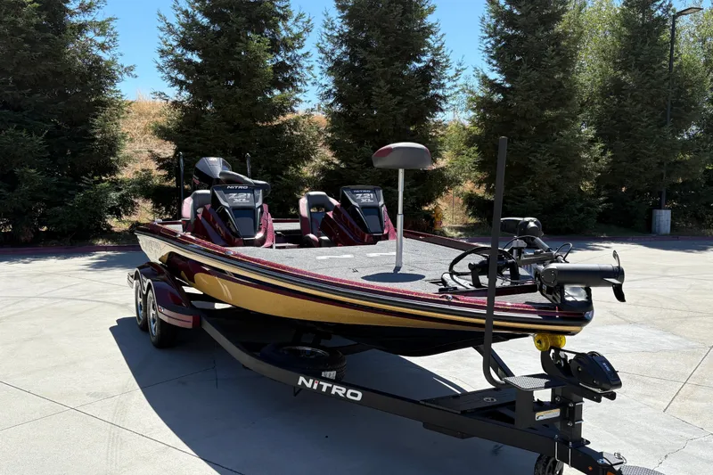 Slide: The Image of 2026 Nitro Z21 XL Pro bass boat on trailer, parked outdoors. - 3