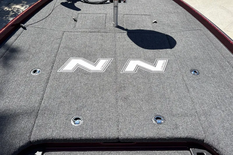 Slide: The Image of 2026 Nitro Z21 XL Pro boat deck with logo, featuring gray carpeting and storage compartments. - 16
