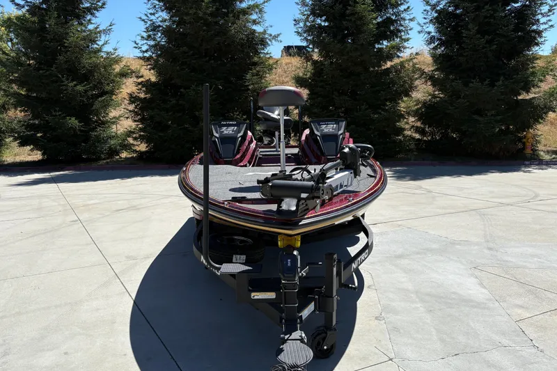 Slide: The Image of 2026 Nitro Z21 XL Pro boat on a concrete driveway, surrounded by trees. - 11