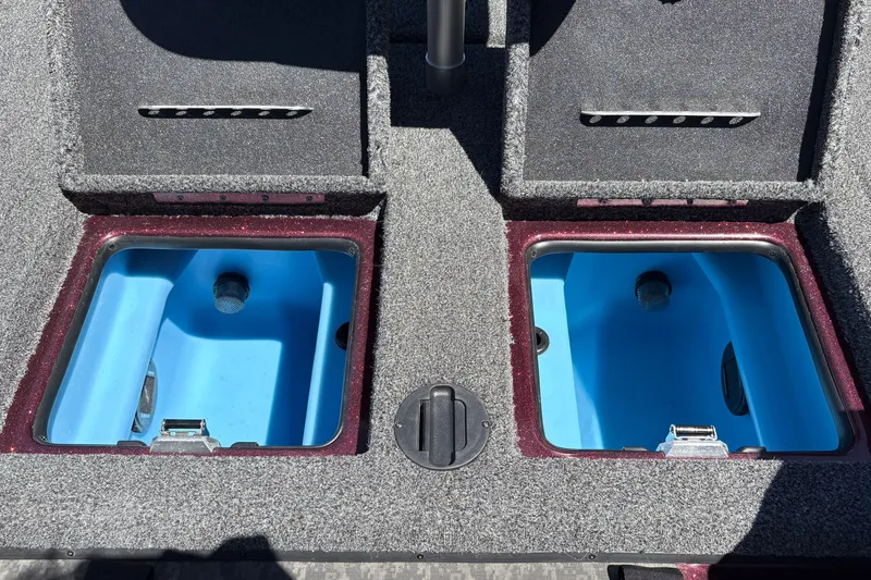 Slide: The Image of 2026 Nitro Z21 XL Pro boat livewells with blue interiors and carpeted deck. - 39