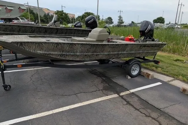 Slide: The Image of 2026 Tracker Grizzly 1648 SC boat on trailer in parking lot. - 7