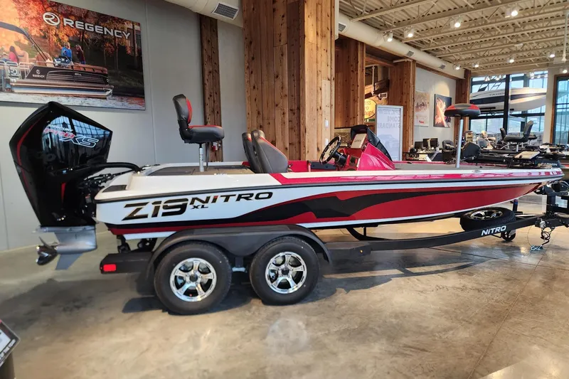 The Image of 2026 Nitro Z19 XL Pro boat in showroom, red and white design, on trailer. - 0