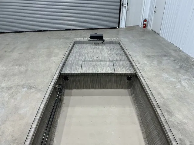 Slide: The Image of 2026 Gator Tail 1754 Extreme Rear Dual Pods boat in a garage setting. - 11