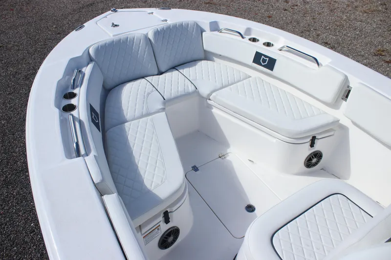 Slide: The Image of 2026 Sea Fox 248 Commander boat interior with white cushioned seating and cup holders. - 13