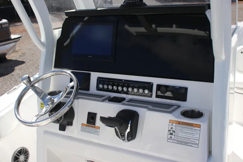 Slide: The Image of 2026 Sea Fox 248 Commander boat dashboard with steering wheel and control panel. - 6