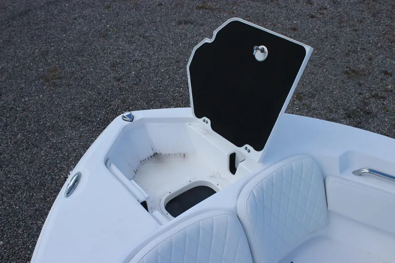 Slide: The Image of 2026 Sea Fox 248 Commander boat with open storage compartment and cushioned seating. - 8