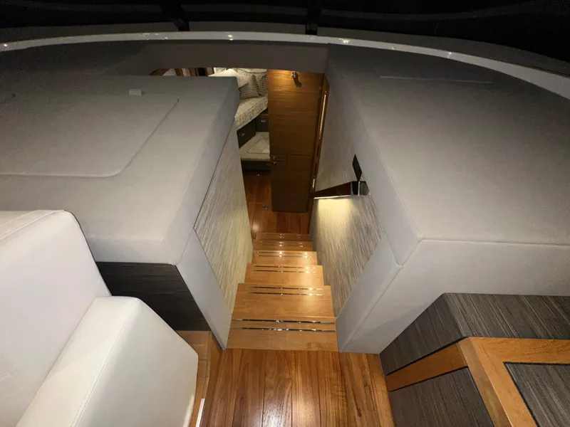 Slide: The Image of Interior of 2020 Tiara Yachts F53 Flybridge, featuring wooden stairs and modern design. - 15
