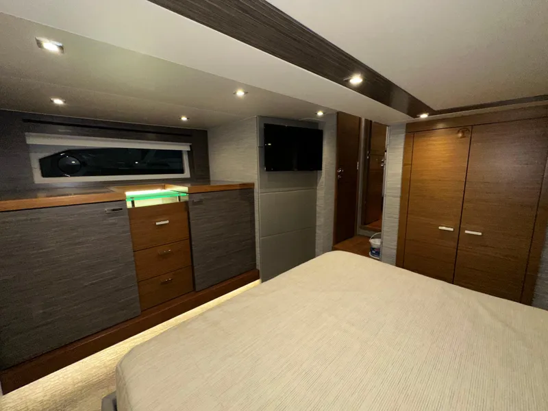 Slide: The Image of Luxurious interior of 2020 Tiara Yachts F53 Flybridge with modern wood cabinetry and ambient lighting. - 27