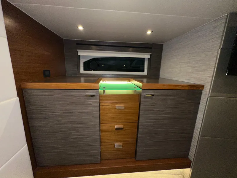 Slide: The Image of Luxurious interior of 2020 Tiara Yachts F53 Flybridge with modern cabinetry and ambient lighting. - 29