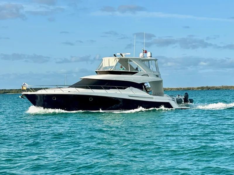 Slide: The Image of 2020 Tiara Yachts F53 Flybridge cruising on blue water under a clear sky. - 3