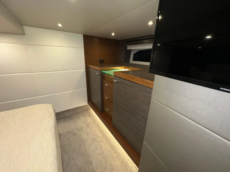 Slide: The Image of Luxurious interior of 2020 Tiara Yachts F53 Flybridge with modern cabinetry and TV. - 30
