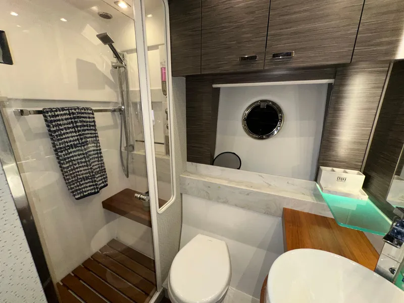 Slide: The Image of Luxurious bathroom in 2020 Tiara Yachts F53 Flybridge with modern fixtures and wooden accents. - 32
