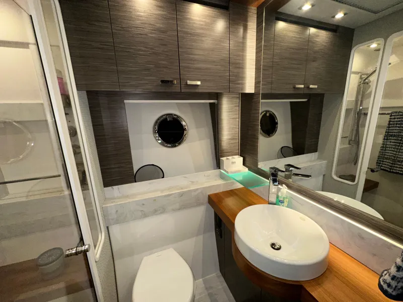 Slide: The Image of Luxurious bathroom in 2020 Tiara Yachts F53 Flybridge with modern fixtures and wood accents. - 33