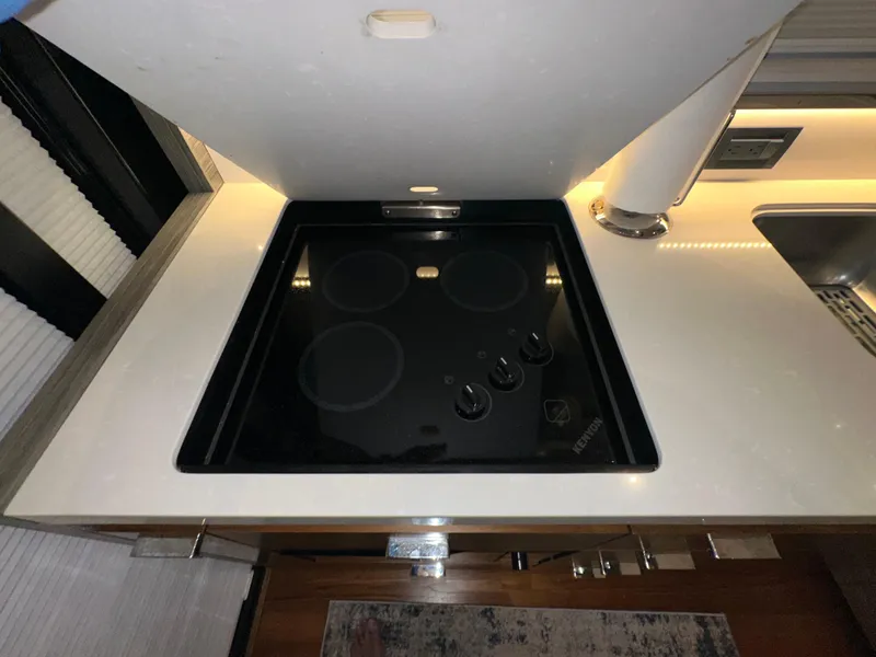 Slide: The Image of Modern kitchen stove in 2020 Tiara Yachts F53 Flybridge, featuring sleek design and controls. - 43