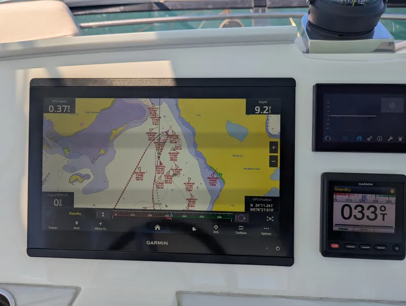 Slide: The Image of Garmin navigation display on 2020 Tiara Yachts F53 Flybridge, showing nautical chart and compass. - 47