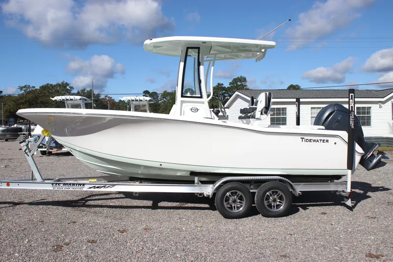 Slide: The Image of 2026 Tidewater 220 LXF boat on trailer, parked outdoors under a blue sky. - 1