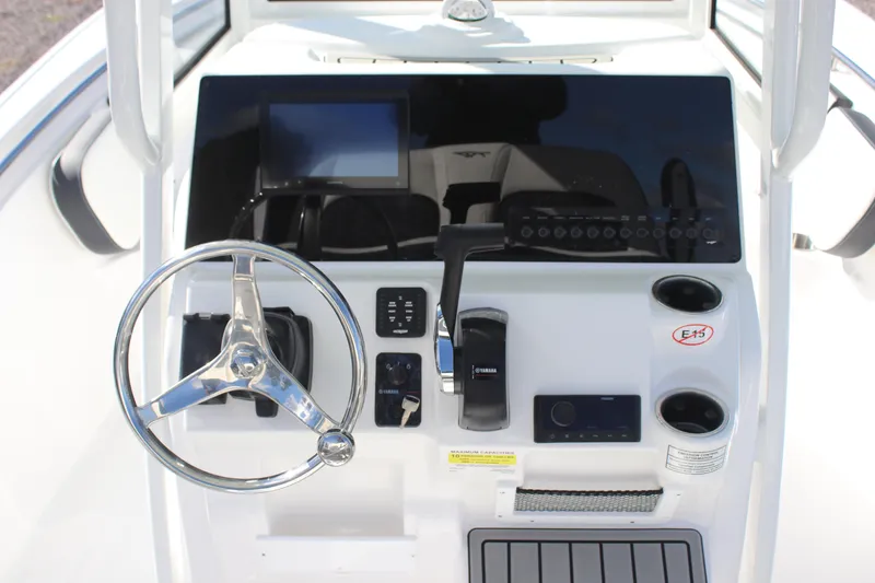 Slide: The Image of 2026 Tidewater 220 LXF boat console with steering wheel and controls. - 14