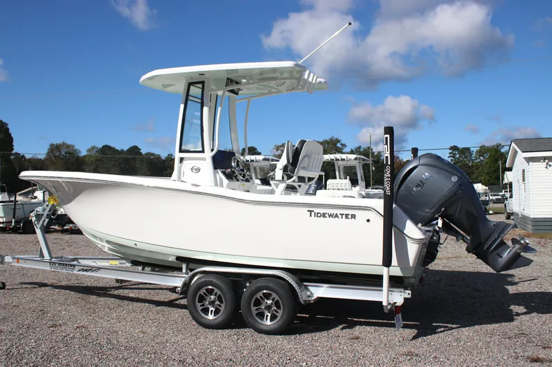 Slide: The Image of 2026 Tidewater 220 LXF boat on trailer, parked outdoors under blue sky. - 2