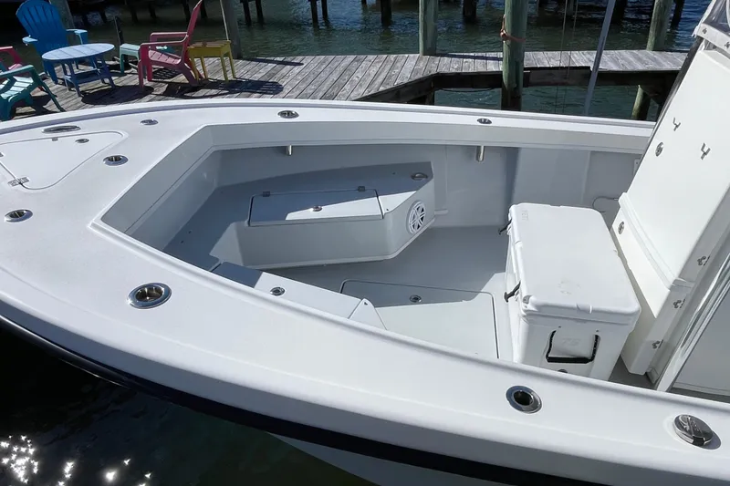 Slide: The Image of 2023 Pair Customs 24 Center Console DV boat interior with seating and storage. - 11