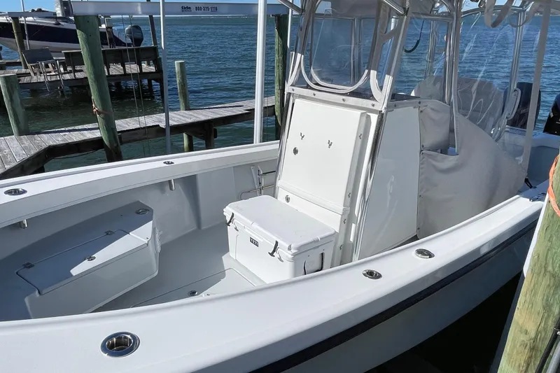 Slide: The Image of 2023 Pair Customs 24 Center Console DV boat docked by the water. - 13