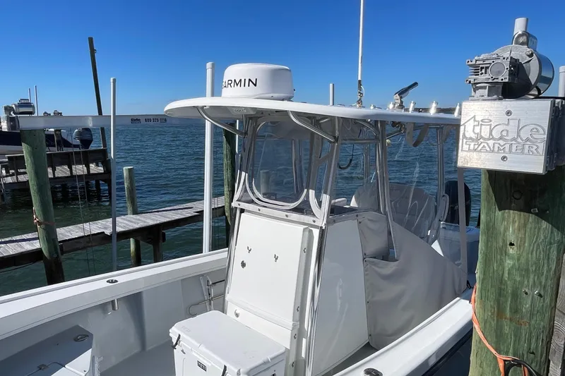Slide: The Image of 2023 Pair Customs 24 Center Console DV boat docked by the water. - 14