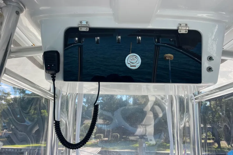 Slide: The Image of 2023 Pair Customs 24 Center Console DV boat dashboard with radio and reflective panel. - 15