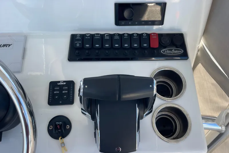 Slide: The Image of Control panel of 2023 Pair Customs 24 Center Console DV boat with switches and throttle. - 16