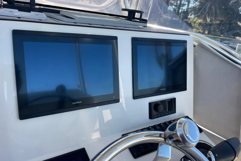 Slide: The Image of 2023 Pair Customs 24 Center Console DV with dual Garmin displays and steering wheel. - 17