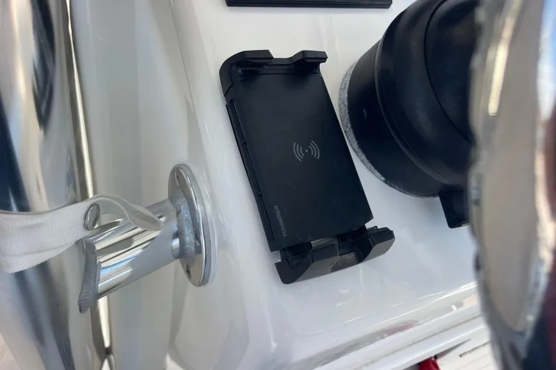 Slide: The Image of Close-up of 2023 Pair Customs 24 Center Console DV dashboard with phone holder and steering wheel. - 18