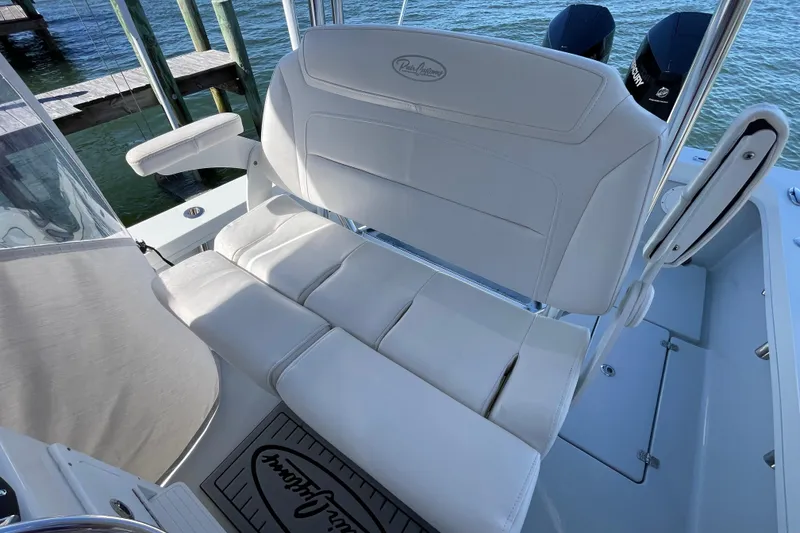 Slide: The Image of 2023 Pair Customs 24 Center Console DV boat with white seating and dual engines. - 23