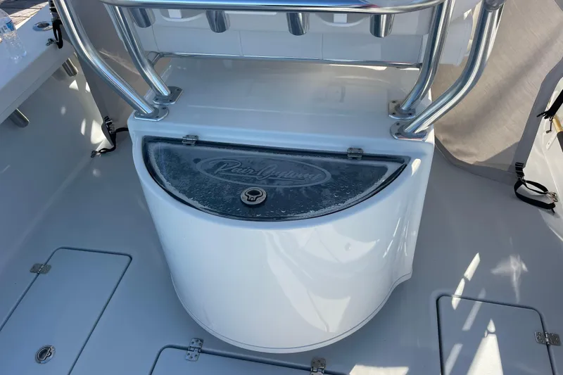 Slide: The Image of 2023 Pair Customs 24 Center Console DV boat interior with storage compartment. - 25