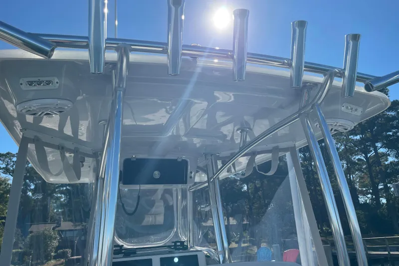 Slide: The Image of 2023 Pair Customs 24 Center Console DV boat with stainless steel T-top under sunny sky. - 26