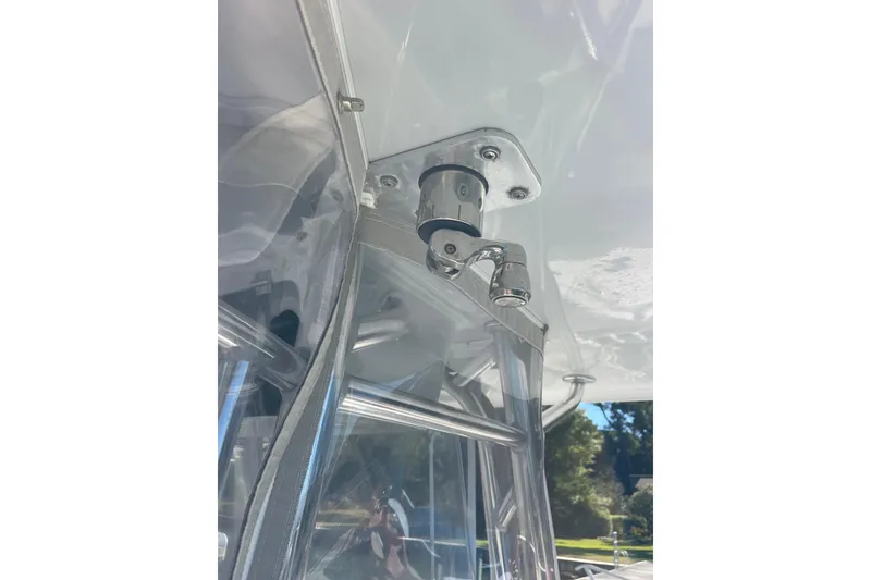 Slide: The Image of 2023 Pair Customs 24 Center Console DV boat detail, featuring stainless steel hardware and clear enclosure. - 29