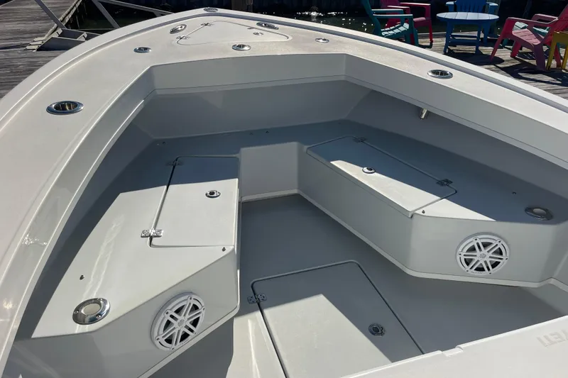Slide: The Image of 2023 Pair Customs 24 Center Console DV boat interior with seating and storage compartments. - 30