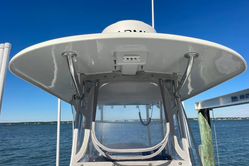 Slide: The Image of 2023 Pair Customs 24 Center Console DV boat on water, showcasing helm and canopy. - 31