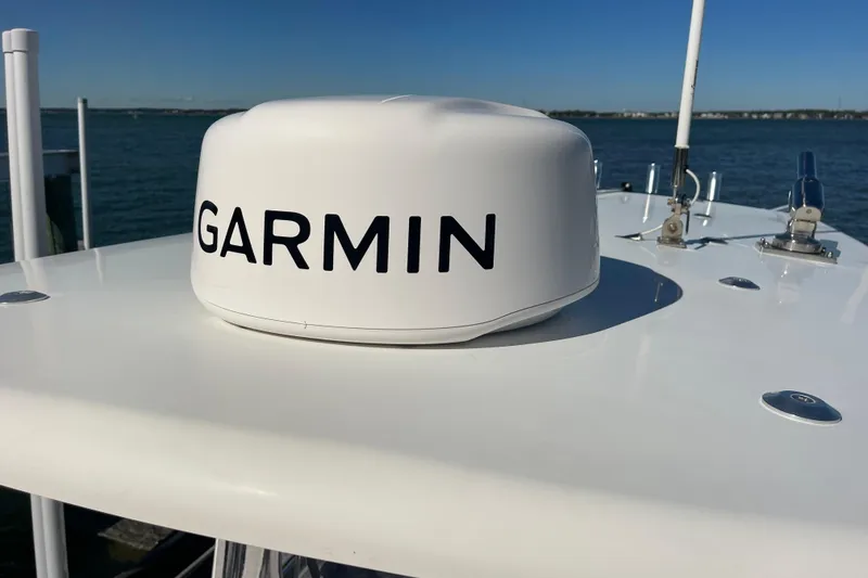 Slide: The Image of 2023 Pair Customs 24 Center Console DV with Garmin marine equipment on deck. - 32