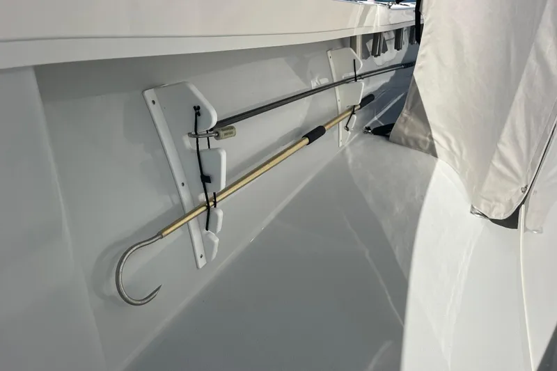 Slide: The Image of 2023 Pair Customs 24 Center Console DV boat interior with mounted gaff hook. - 34