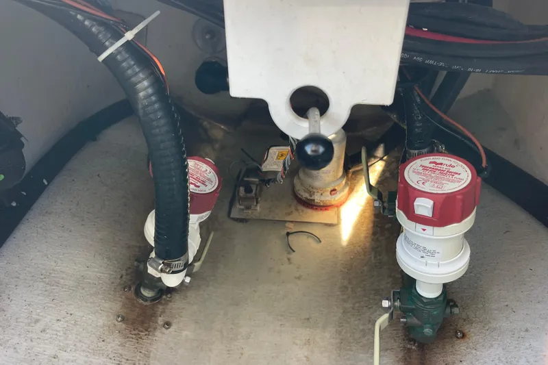 Slide: The Image of 2023 Pair Customs 24 Center Console DV bilge area with pumps and wiring. - 39