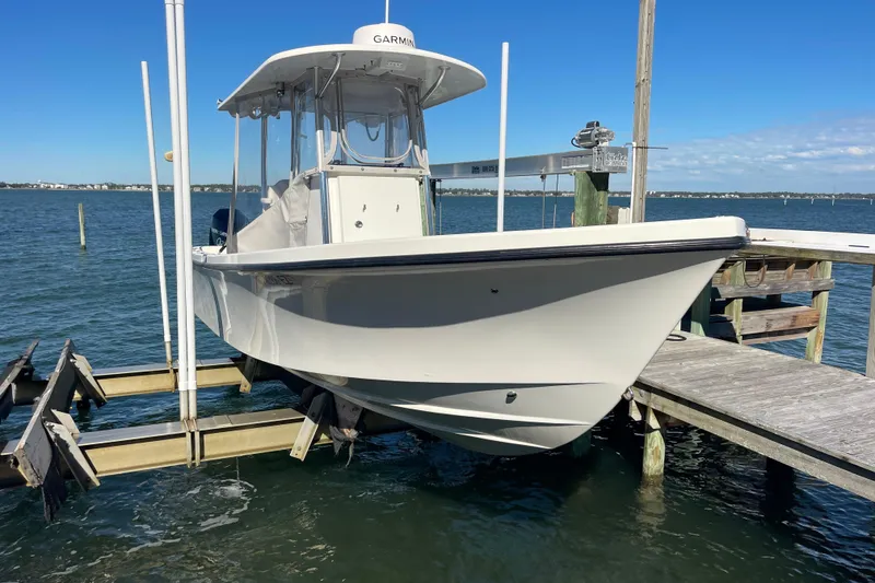 Slide: The Image of 2023 Pair Customs 24 Center Console DV boat docked by the water. - 40