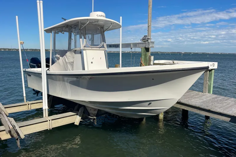 Slide: The Image of 2023 Pair Customs 24 Center Console DV boat docked on a sunny day. - 7