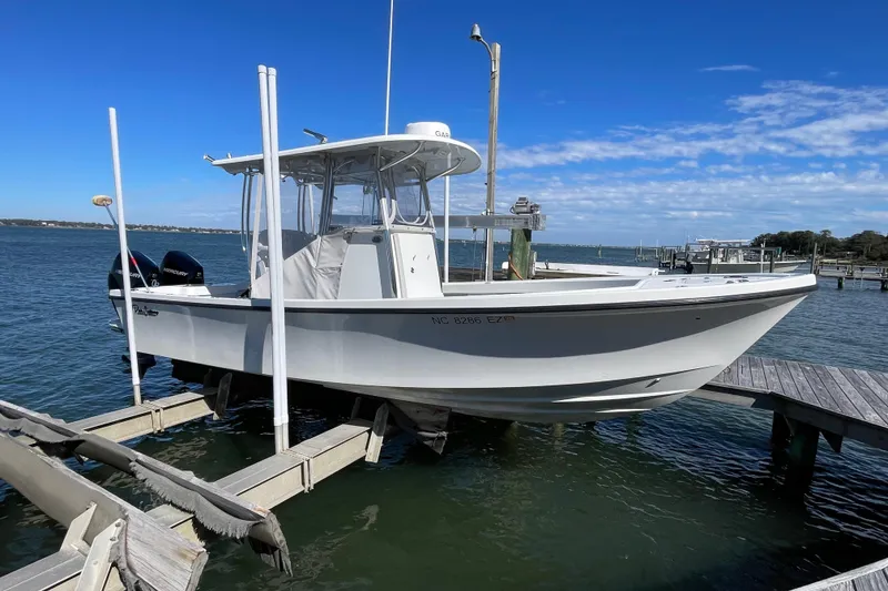Slide: The Image of 2023 Pair Customs 24 Center Console DV boat docked on a sunny day. - 8