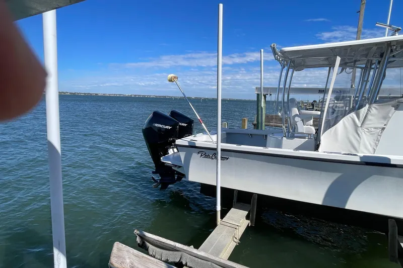 Slide: The Image of 2023 Pair Customs 24 Center Console DV boat docked on a sunny day. - 9