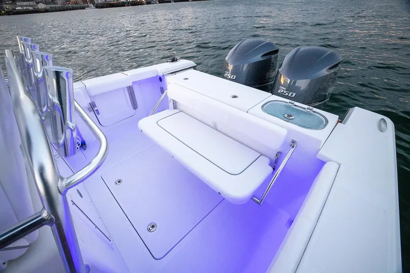 Slide: The Image of Manufacturer Provided Image: 2025 Southport 27 FE boat with dual engines and illuminated seating area. - 11
