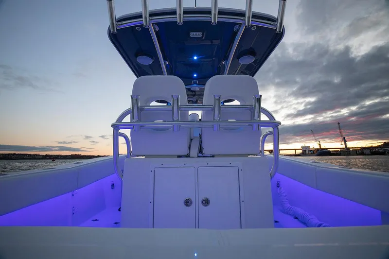 Slide: The Image of Manufacturer Provided Image: 2025 Southport 27 FE boat interior with illuminated seating at sunset. - 6