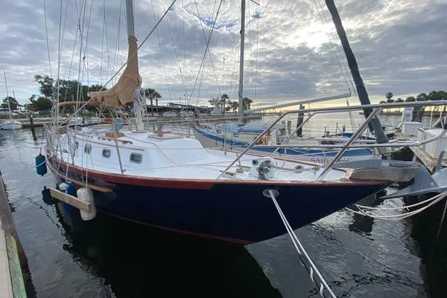 The Image of 1989 Pacific Seacraft Crealock sailboat docked at marina under cloudy sky. - 0