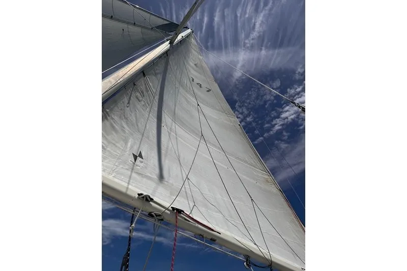 Slide: The Image of Sail of 1989 Pacific Seacraft Crealock against a blue sky with clouds. - 10