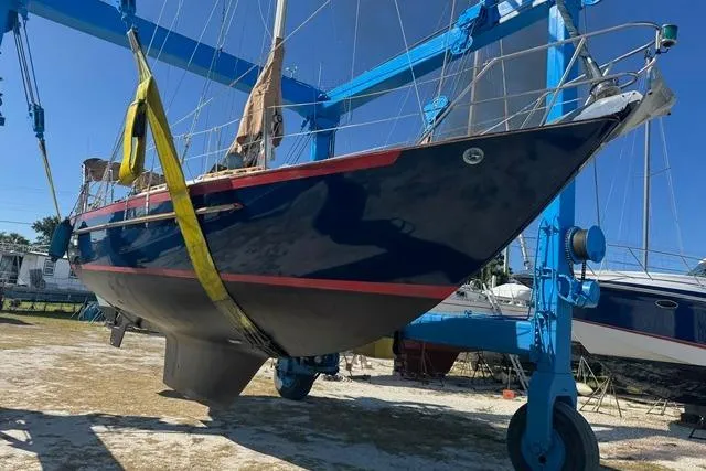 Slide: The Image of 1989 Pacific Seacraft Crealock sailboat in dry dock, supported by blue hoist. - 15