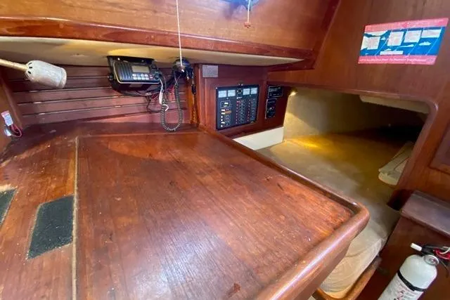 Slide: The Image of 1989 Pacific Seacraft Crealock cabin interior with navigation station and cozy sleeping area. - 20