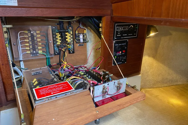 Slide: The Image of Electrical panel of a 1989 Pacific Seacraft Crealock sailboat, showcasing wiring and circuit components. - 23