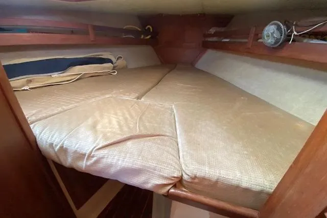 Slide: The Image of 1989 Pacific Seacraft Crealock cabin interior with cushioned sleeping area. - 26